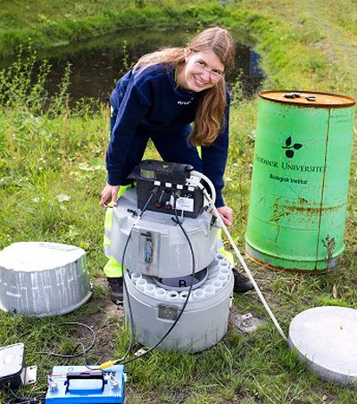 Umweltingenieurin Melanie Sønderup testet an einem Tümpel den Wasserfilter aus Betonpulver.