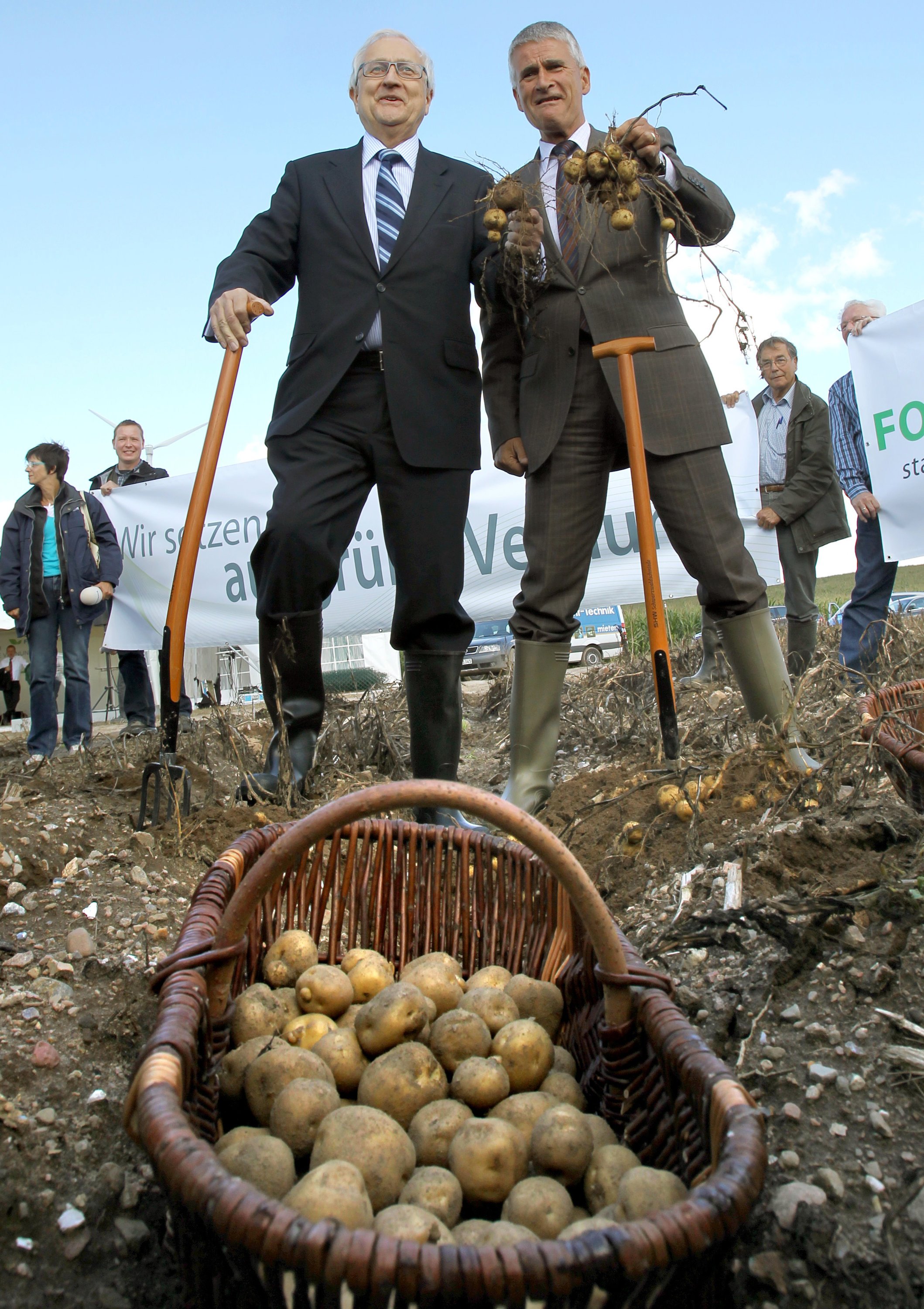 Der frühere Bundeswirtschaftsminister Rainer Brüderle (l, FDP) und BASF-Vorstand Jürgen Hambrecht (r) ernteten am Dienstag 31. August 2010 auf einem Feld bei Zepkow im Müritz-Kreis die ersten in Deutschland angebauten Knollen der gentechnisch veränderten Kartoffel Amflora. Während der Veranstaltung protestierten Gentechnikgegner gegen den Anbau gentechnisch veränderter Pflanzen.