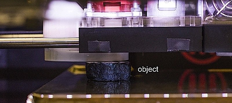 Mit einer Fräse hobelt der modifizierte 3D-Drucker Schicht für Schicht vom Objekt ab. Er pausiert regelmäßig, damit die Kamera von oben Fotos schießen kann.