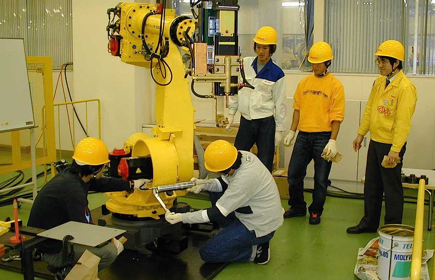 Ingenieure des japanischen Unternehmens Fanuc bauen einen Roboterarm zusammen. Die Technik Deep Learning soll Roboter zu selbstständigem Lernen befähigen. 