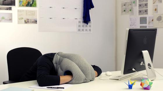 Ein kurzes Nickerchen im Büro steigert die Leistungskraft enorm. Inzwischen gibt es sogar Kissen wie das Ostrich-Pillow, das den Büroschlaf besonders bequem macht.