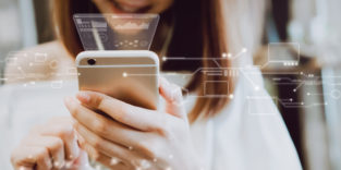 Frau nutzt Smartphone am vernetzten Brüsseler Flughafen