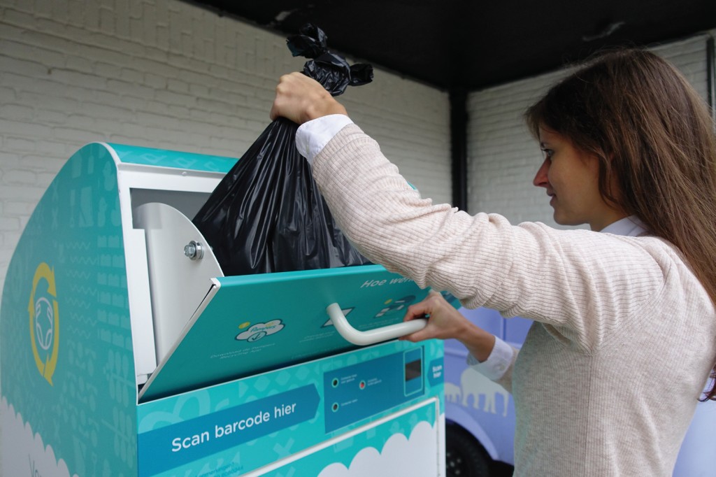 Eine Frau wirft einen Plastikbeutel mit Windeln in die Windelbox. Bild: Procter & Gamble