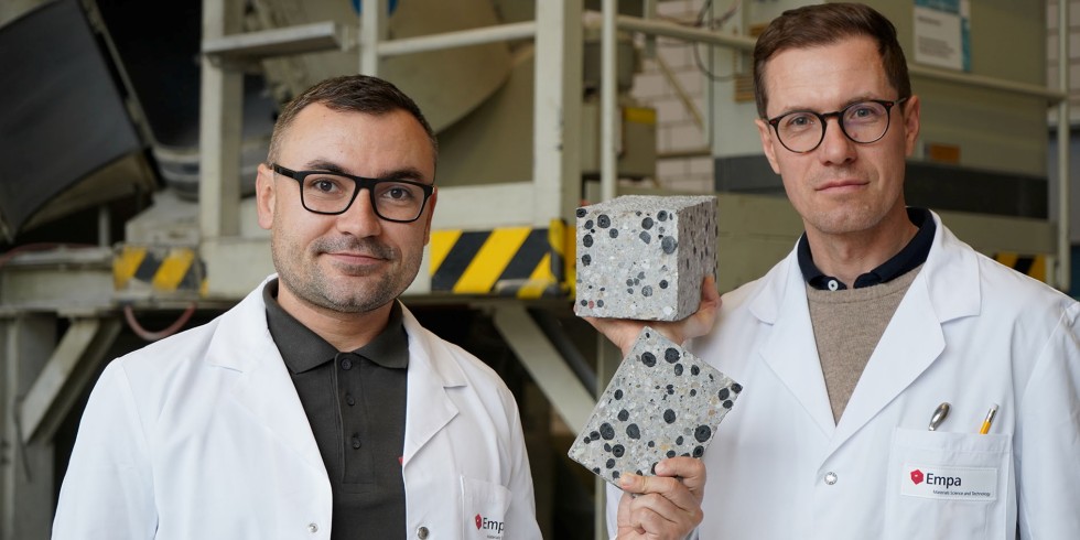 Empa-Forscher Mateusz Wyrzykowski (r.) und Nikolajs Toropovs ersetzen herkömmliche Gesteinskörnungen im Beton durch Pellets aus Pflanzenkohle. Foto: Empa