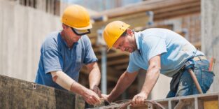 Construction workers working on cement formwork frames