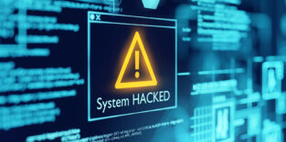 Foto eines PC-Bildschirms, auf dem eine Hackerwarnung zu sehen ist.