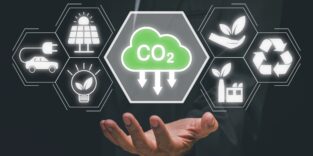 Reduce CO2 emission concept, Person hand holding CO2 icon on virtual screen, Sustainable development and green business based on renewable energy, electric transport.
