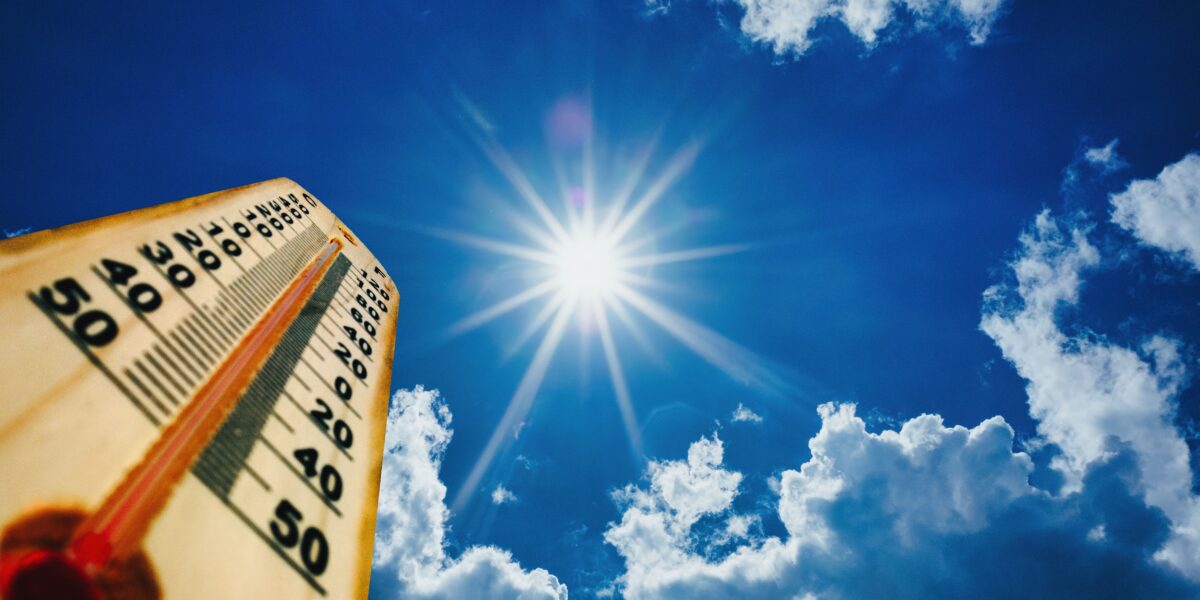 Summer heat, high temperature outdoors, hot desert weather. Thermometer reaching 100 degrees Fahrenheit scale on blue sky background, sunny day. 3d illustration