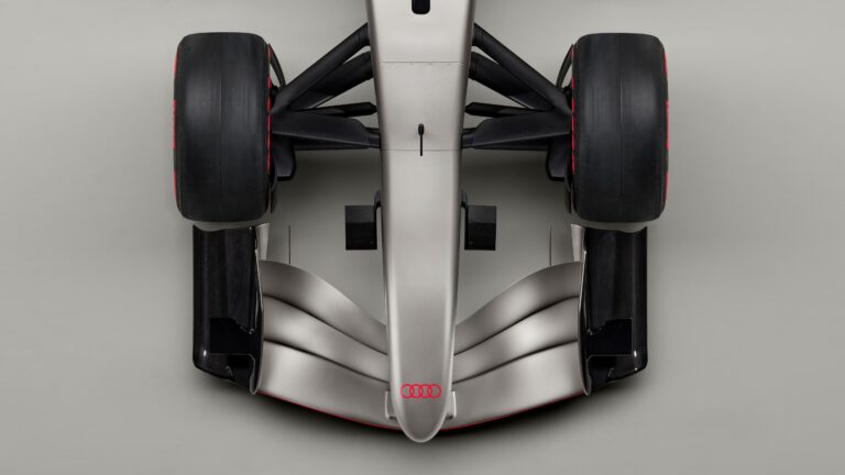 Indoor studio shot, exterior, birds-eye view, detail of wheel suspension, nose, and front wing