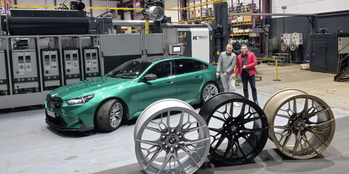 Geschäftsführer von ENTEC-STRACON Ralf Bux (r.) und Mike Seidel, Projektleiter Radentwicklung der BMW Group, deuten auf die bereits im BMW-Fahrzeug eingebaute Rad-Innovation