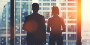 Team von Geschäftspartnern schaut aus dem Fenster