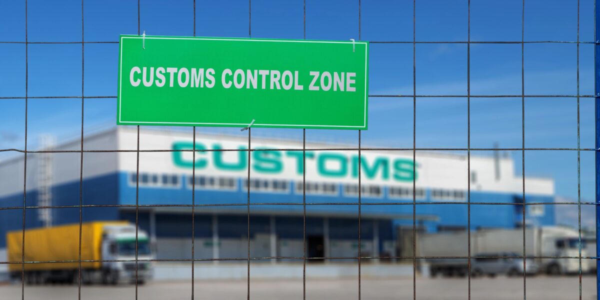 Customs control area with lorries near warehouse logistics center.