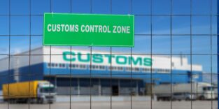 Customs control area with lorries near warehouse logistics center.