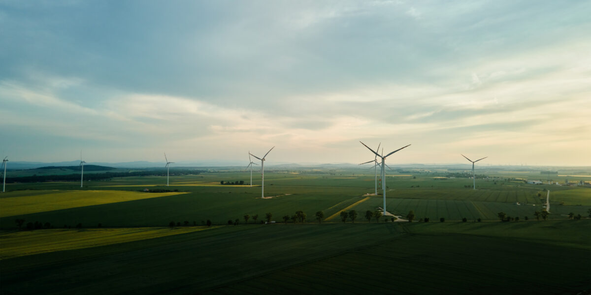 Windmill turbines at sunset, Wind energy concept