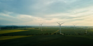 Windmill turbines at sunset, Wind energy concept