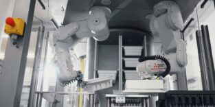 Blick in eine Produktionszelle mit zwei Roboterarmen.