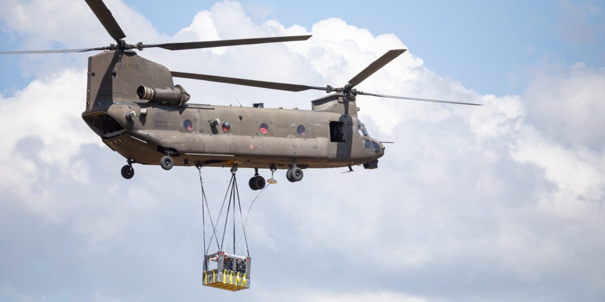 Ein Hubschrauber hebt das Modell des Space Rider in die Luft. Später wird damit ein Falltest durchgeführt.